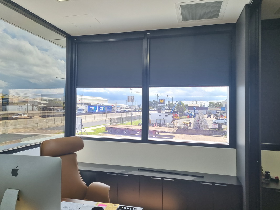partially open blackout blinds in office