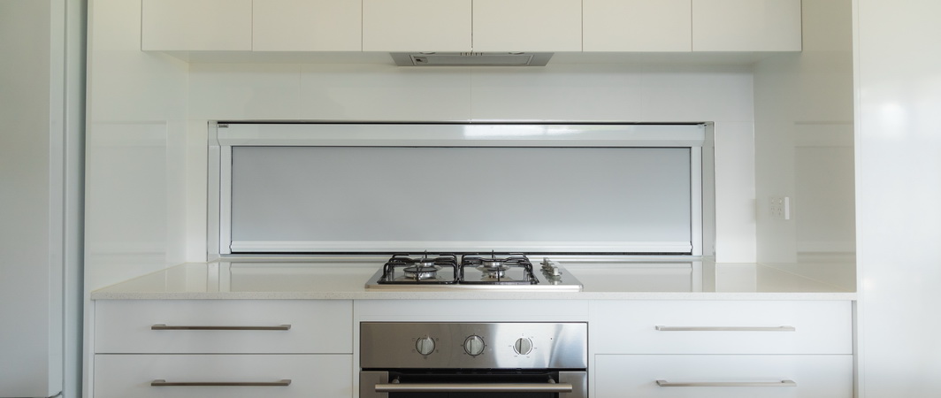 custom height white kitchen blind behind stove
