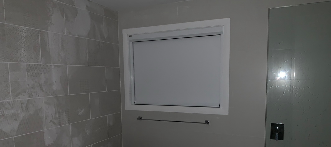bathroom window covered with white blind