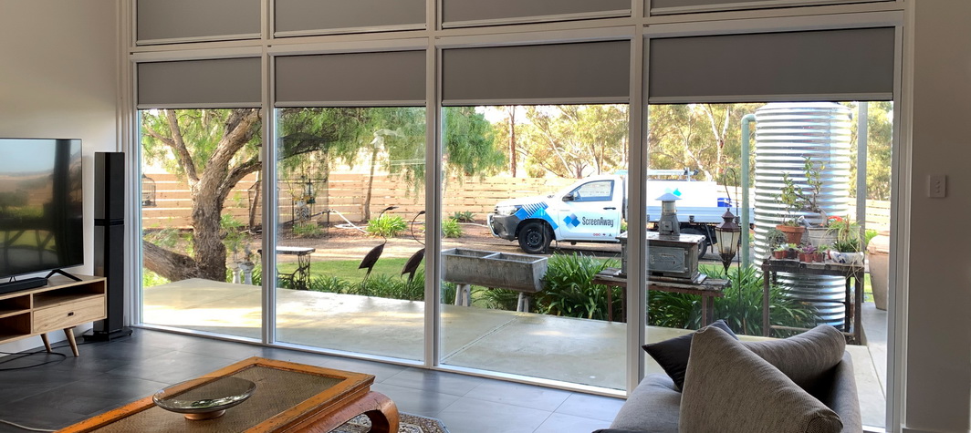 white blinds partially cover ceiling-to-floor windows