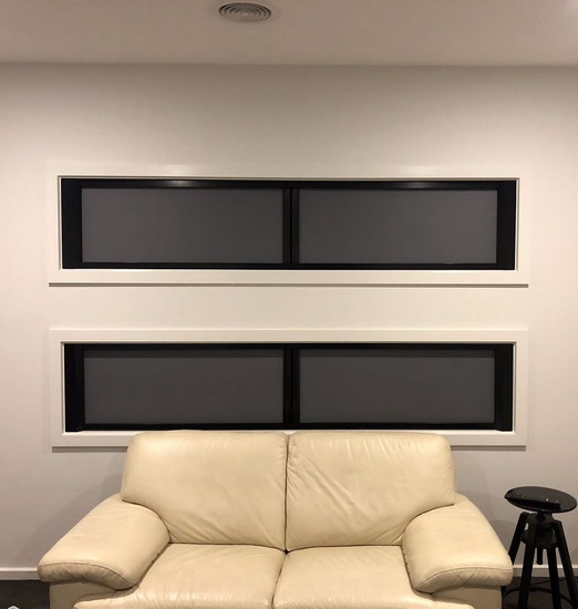 black custom window blinds covering windows in theatre room