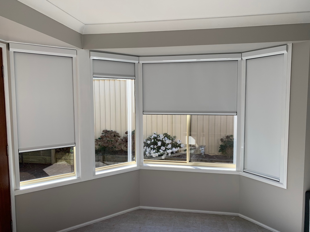 partially open retractable window blinds in living room
