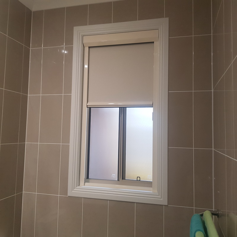 partially open retractable blind in bathroom