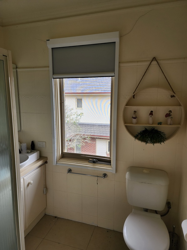open retractable blind in bathroom