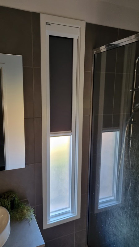 partially open retractable blinds in bathroom