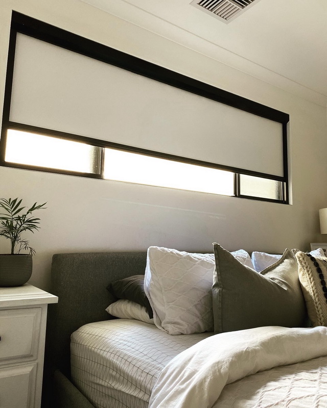 partially open retractable blind in bedroom