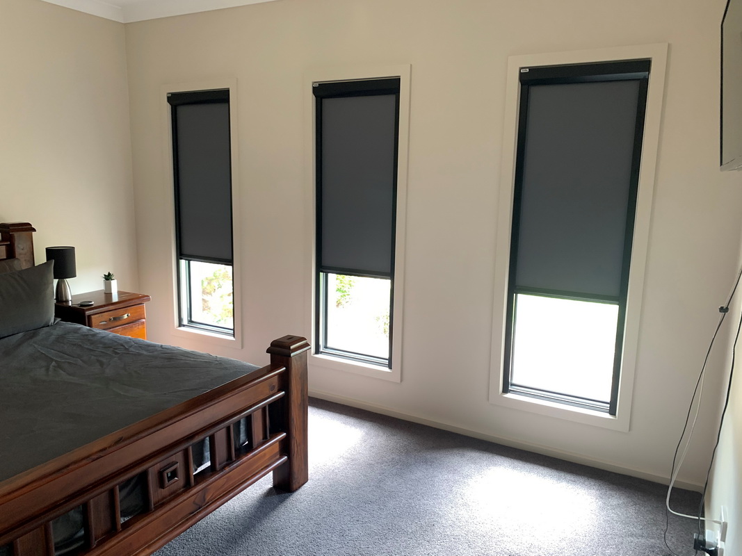 partially open retractable blinds in bedroom