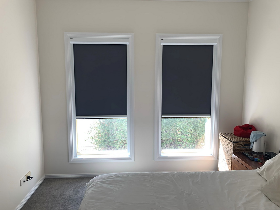 partially open retractable blinds in bedroom