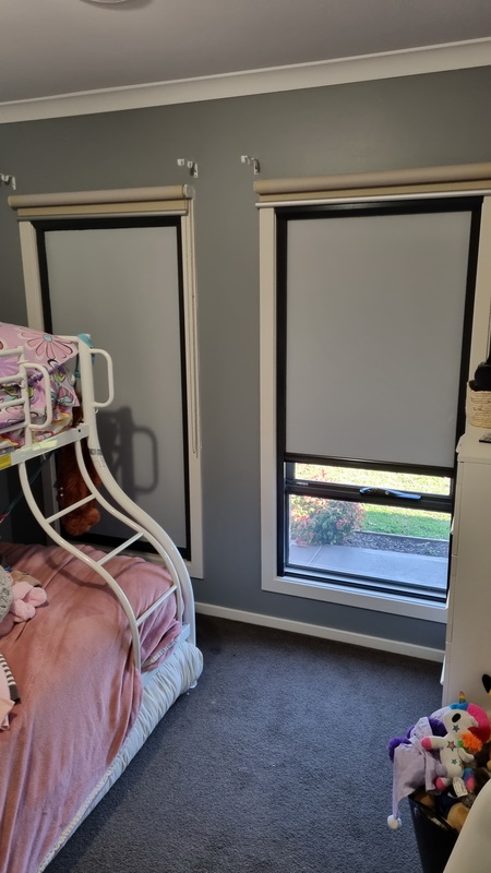 partially open retractable blinds in bedroom