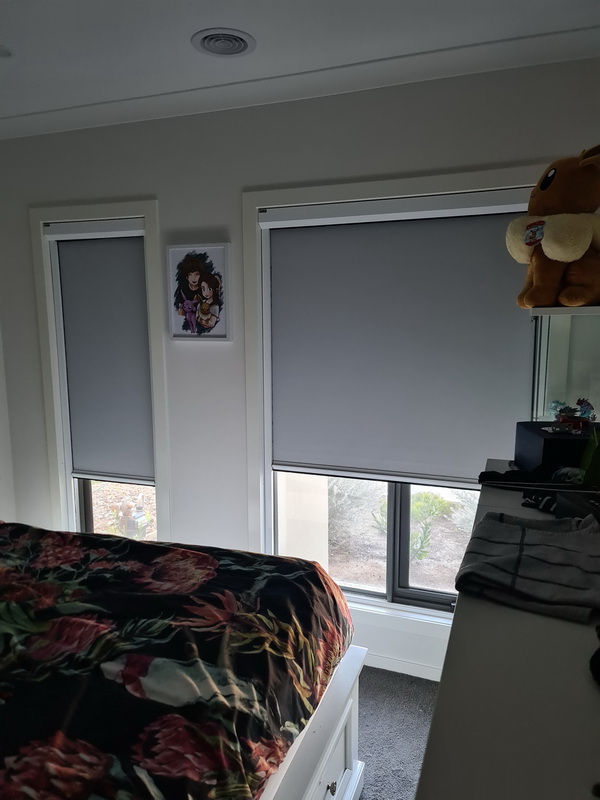 partially open retractable blinds in bedroom
