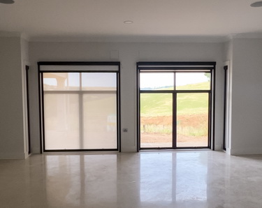 partially closed retractable sheer screens in residential house