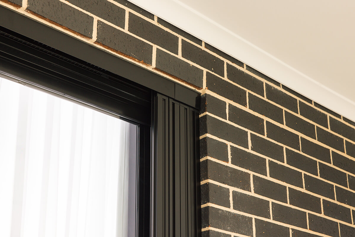 Outdoor patio area with dark-brown brick walls