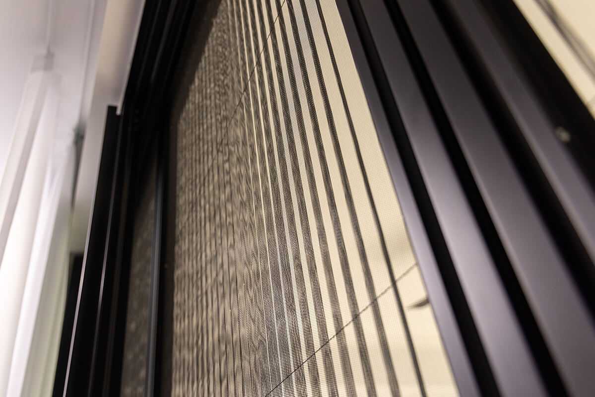 Sliding glass door with a retractable metal screen