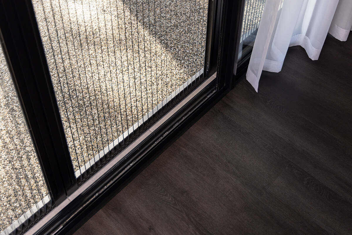 Sliding glass door with a retractable metal screen