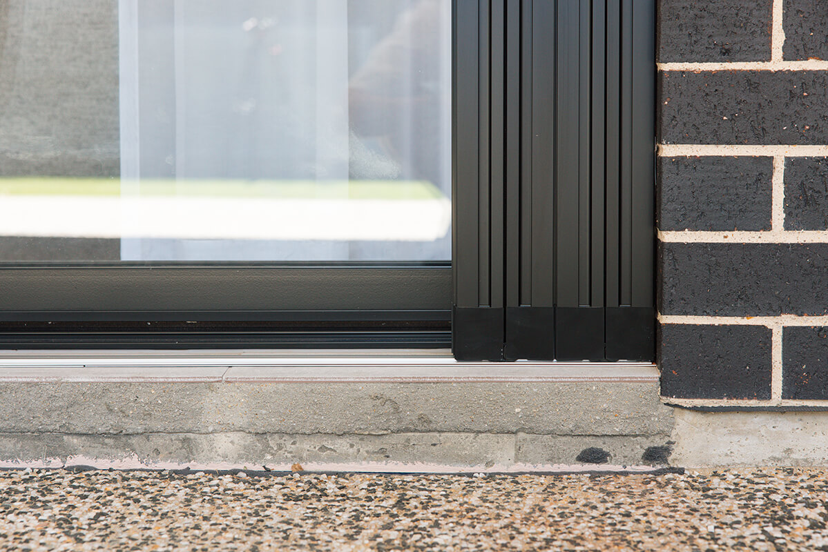 Sliding glass door with a retractable metal screen
