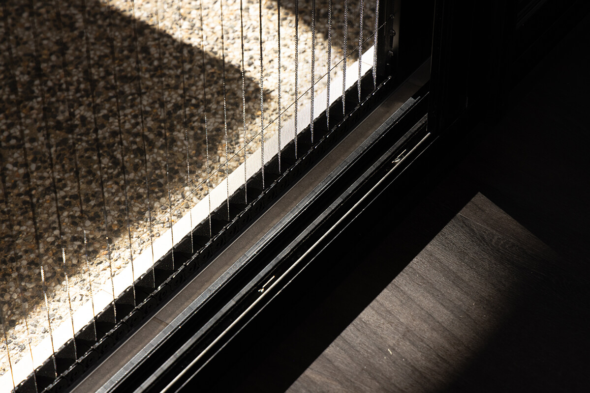 Sliding glass door with a retractable metal screen